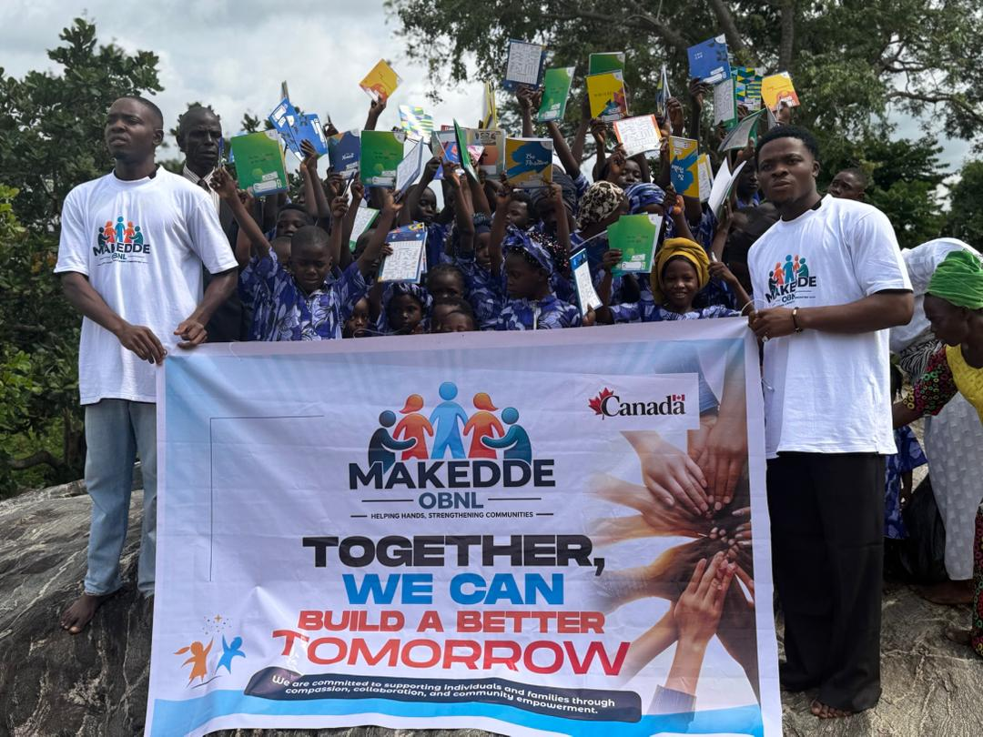 Children holding educational supplies with MAKEDDE volunteers in Nigeria
